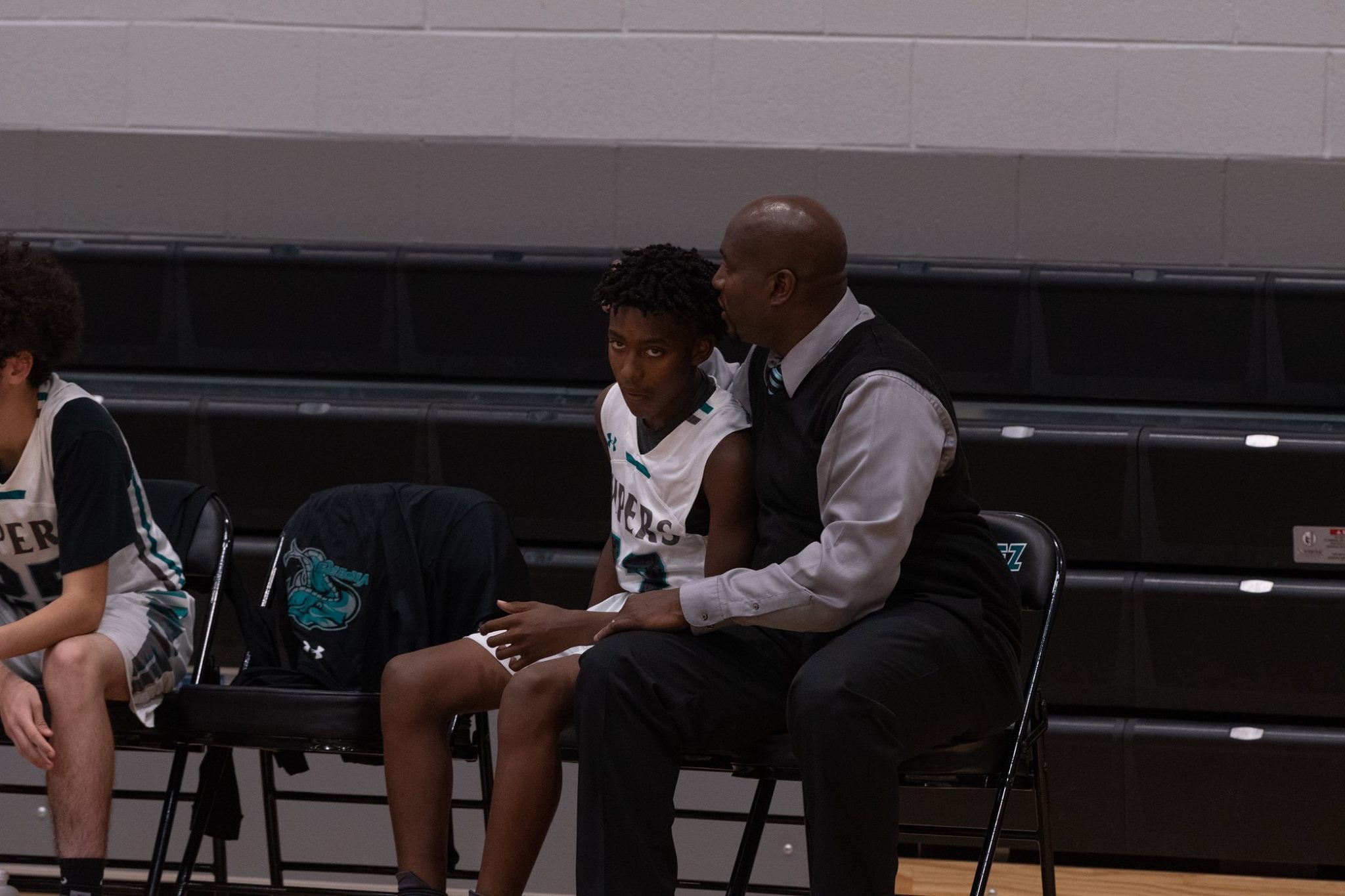 Coach Smith talking it over on the bench with Point Guard Dylan Smith - M.A.N.E. Making Adjustments Not Excuses